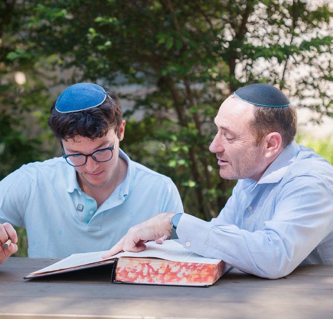 Rabbi Seif learning with a talmid at an outdoor table