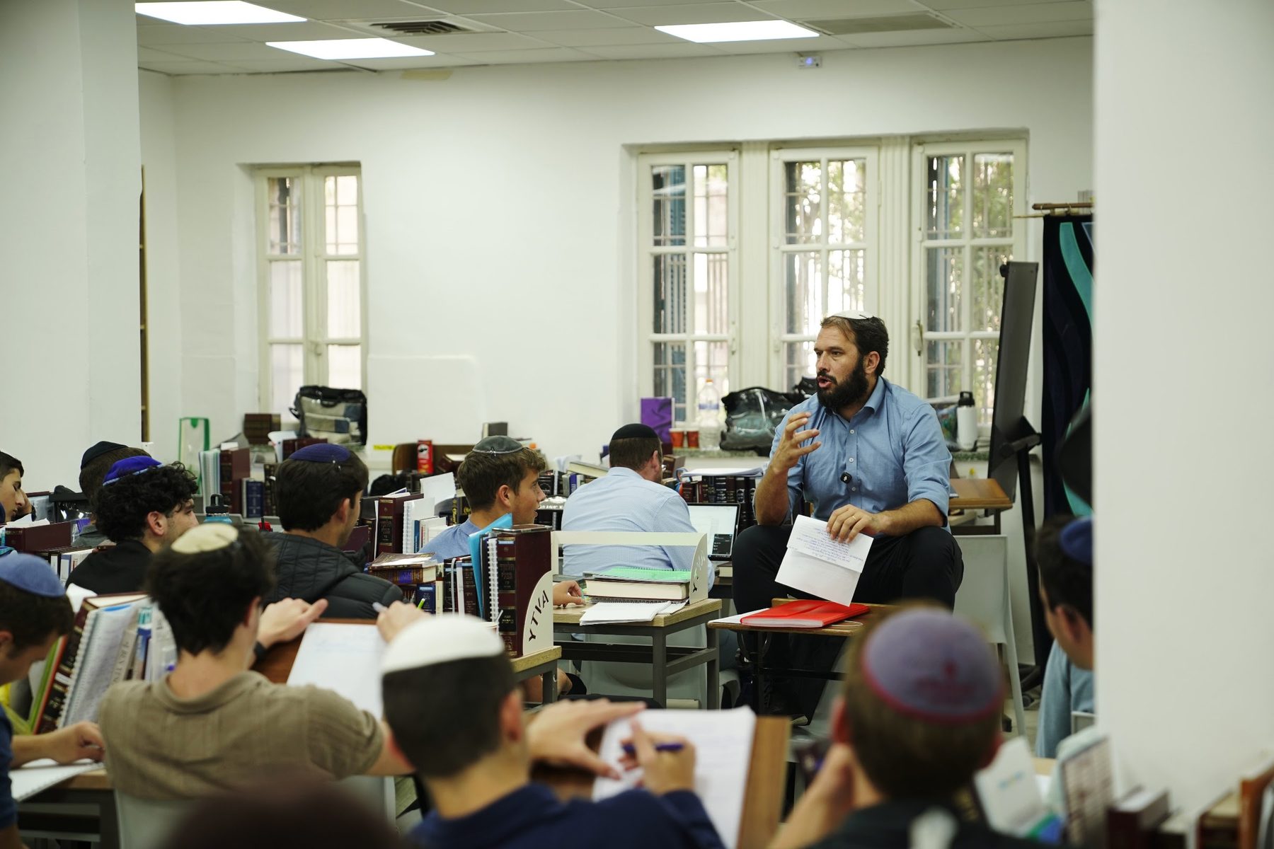 A Rebbe giving shiur to his group in the Beit Midrash