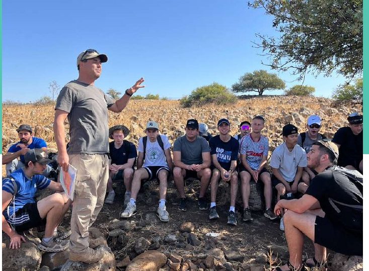 A shiur on the rocks in the middle of a tiyul